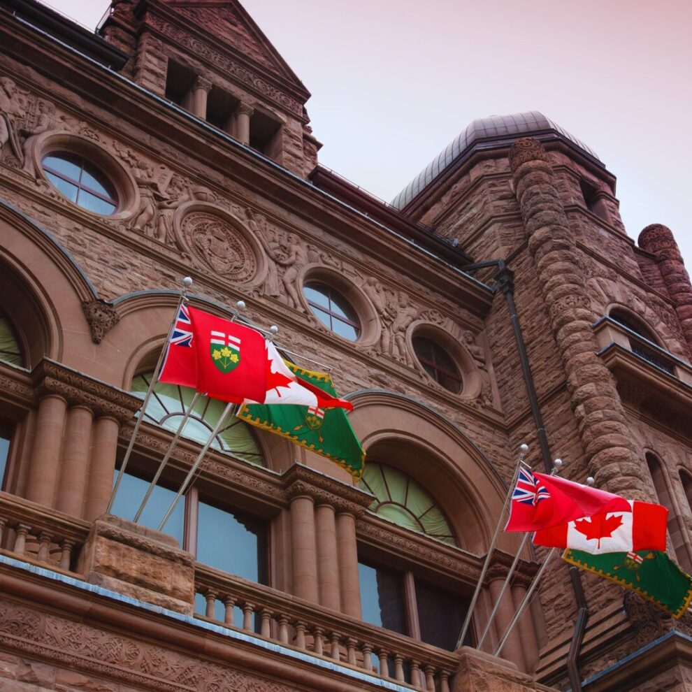 PIA Blog Ontario legislative building with Canadian and Ontario flags waiving out front